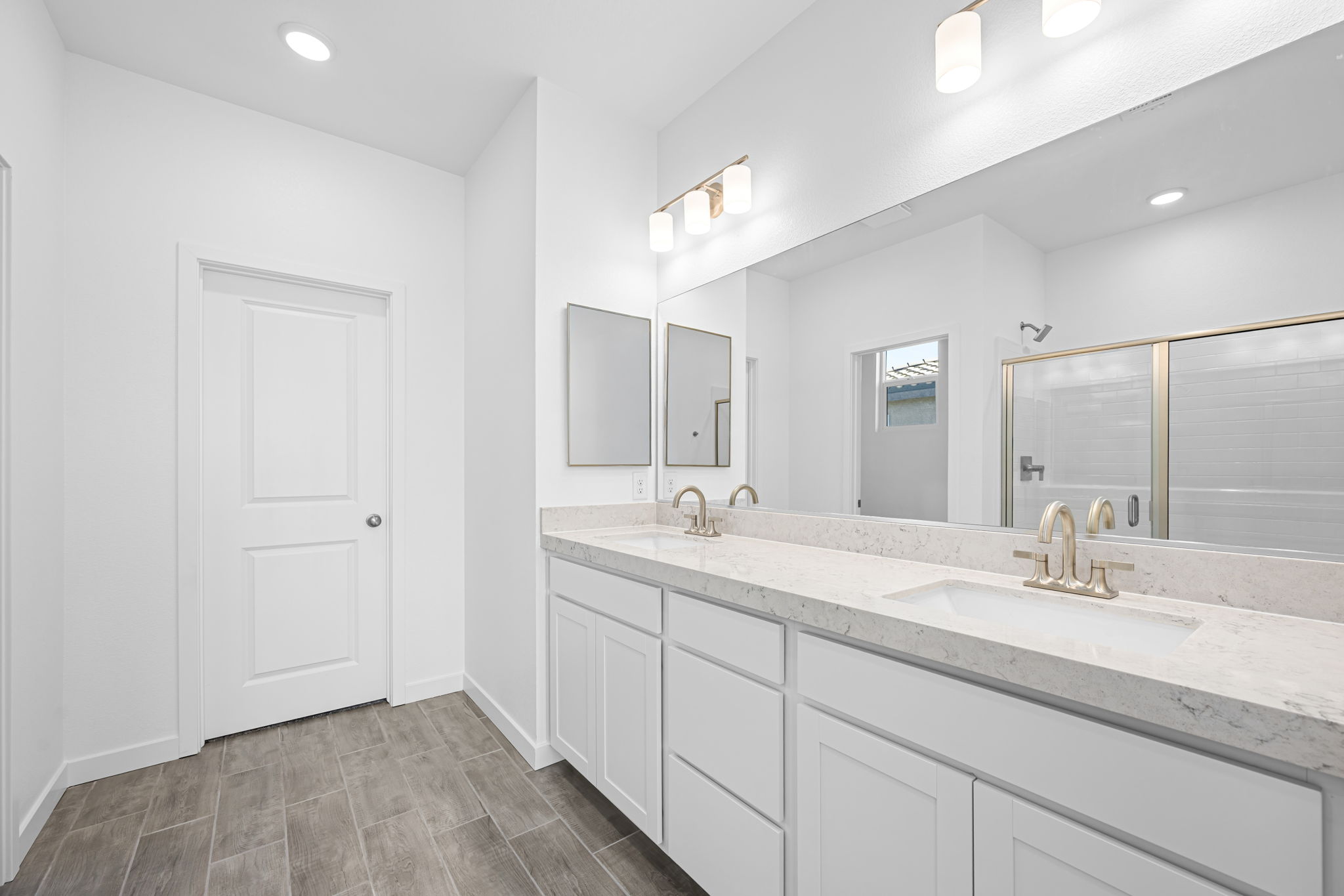 A bathroom with a large mirror.