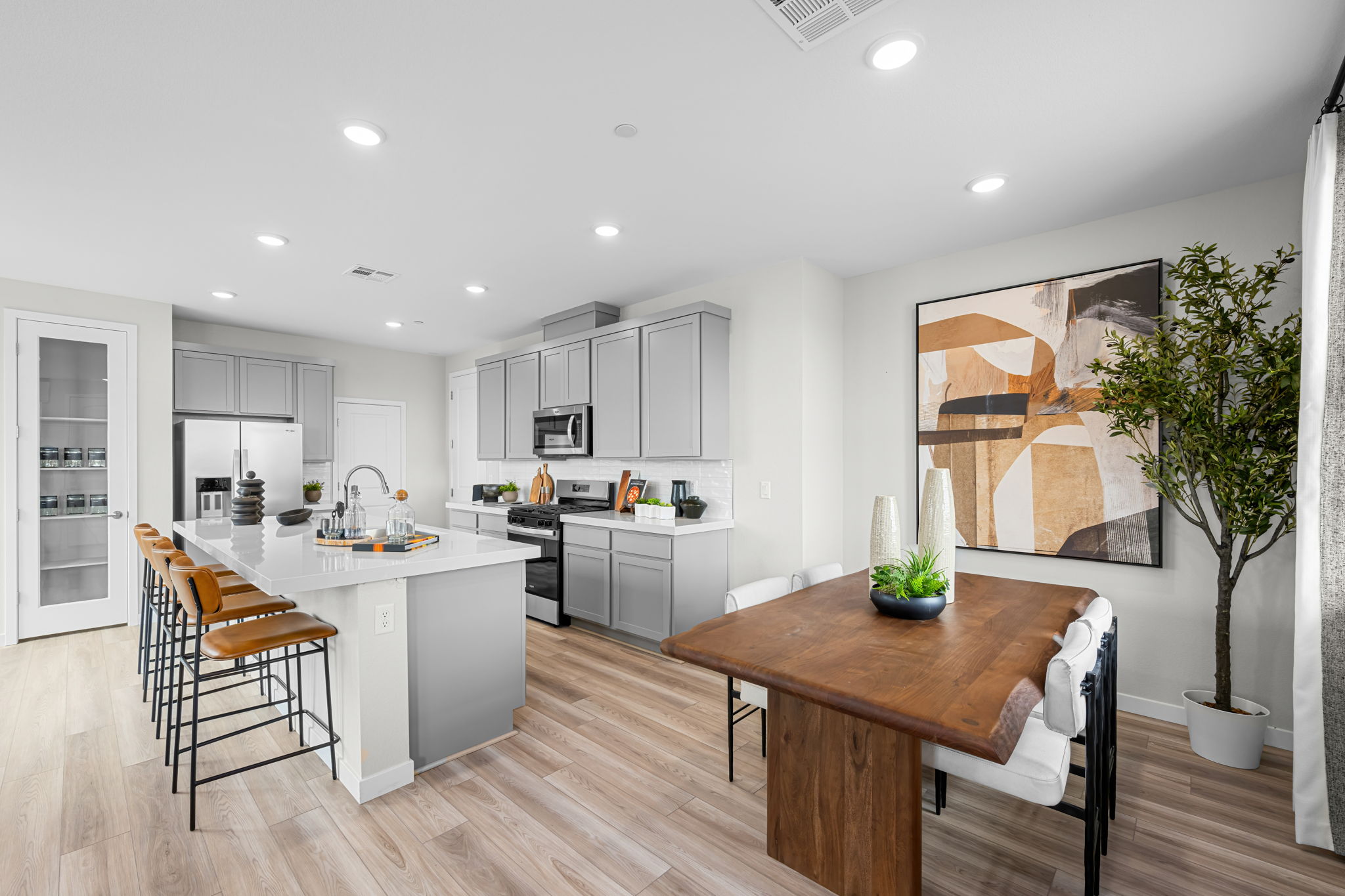 A kitchen with a table and chairs.