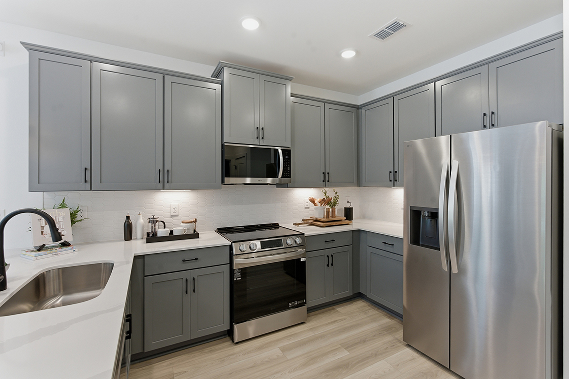 A kitchen with white cabinets.