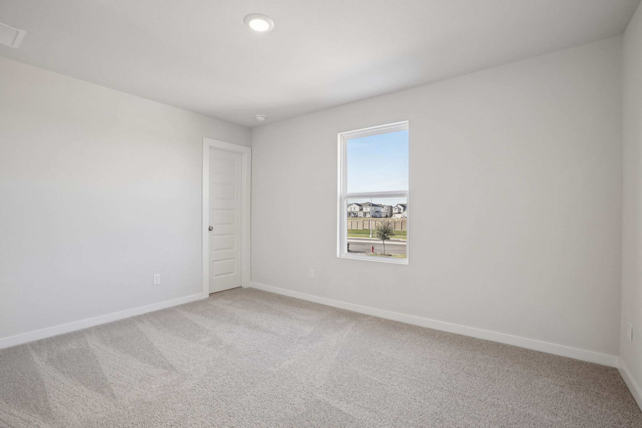 A room with a window and a door.