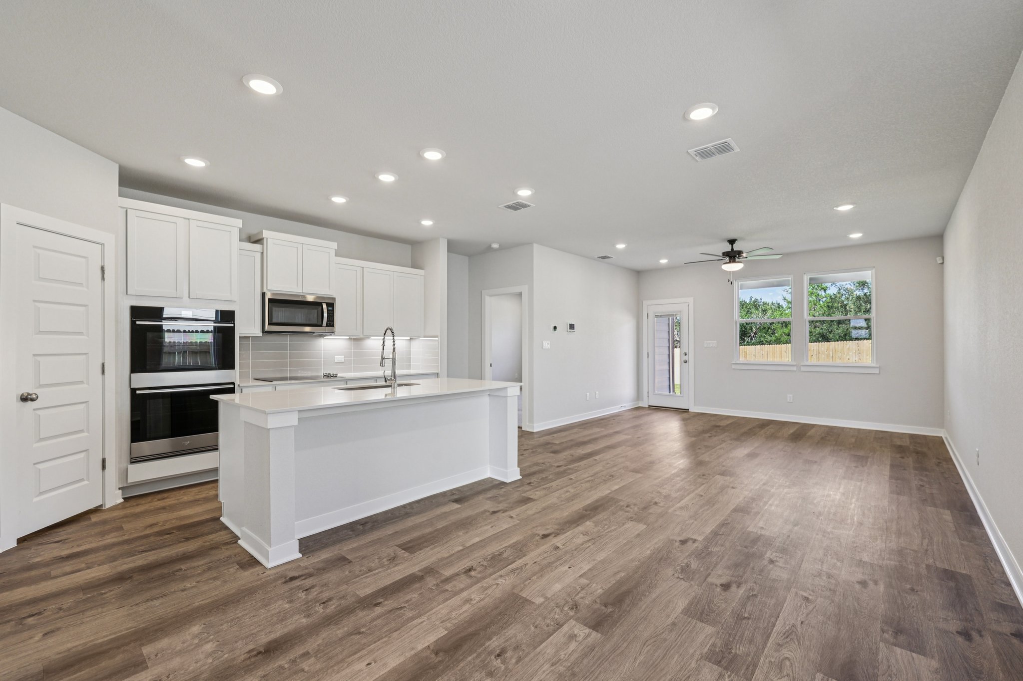 A kitchen with white cabinets.