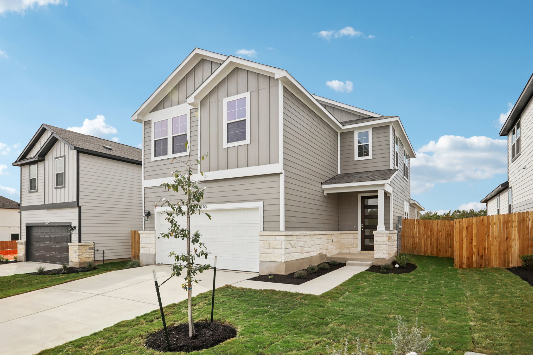 A house with a fence and yard.