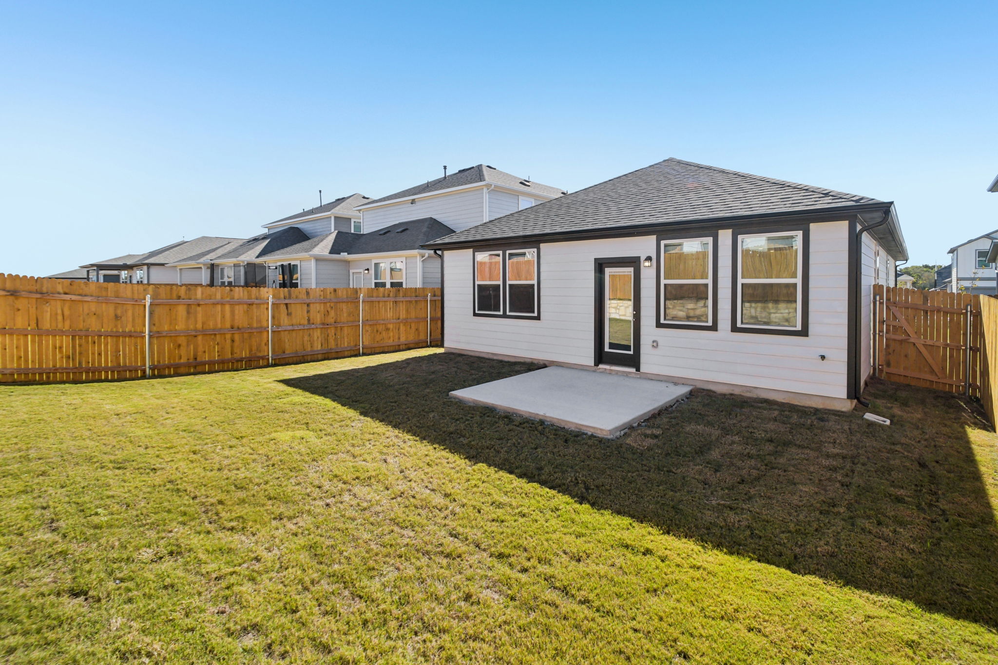 A house with a fence and grass.
