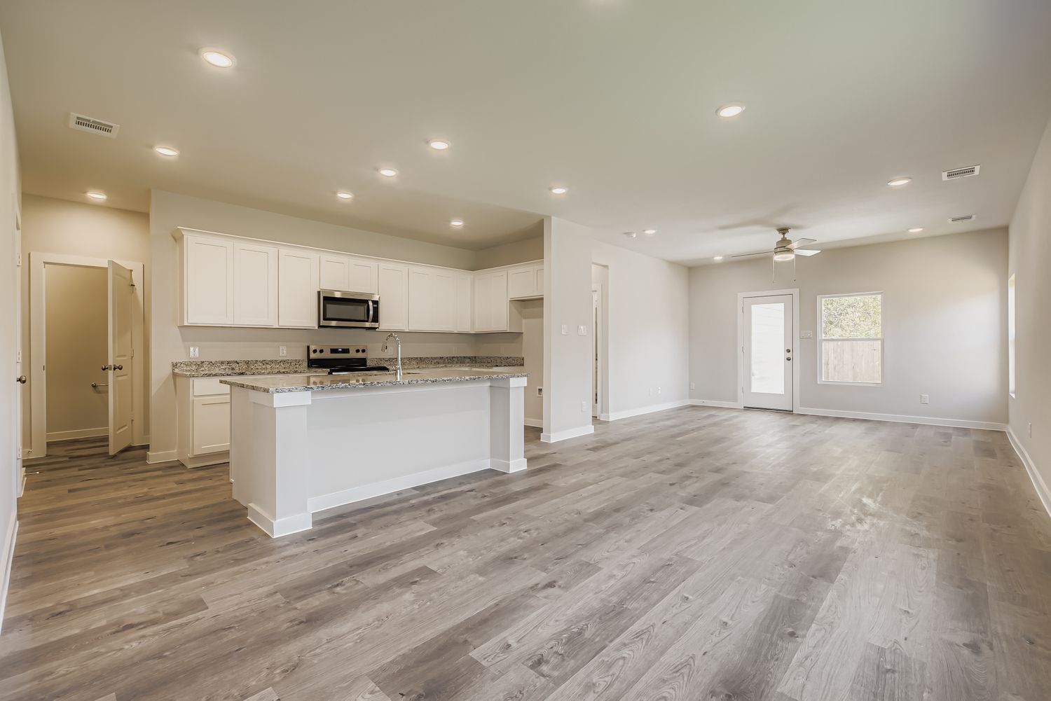 A large kitchen with white cabinets.