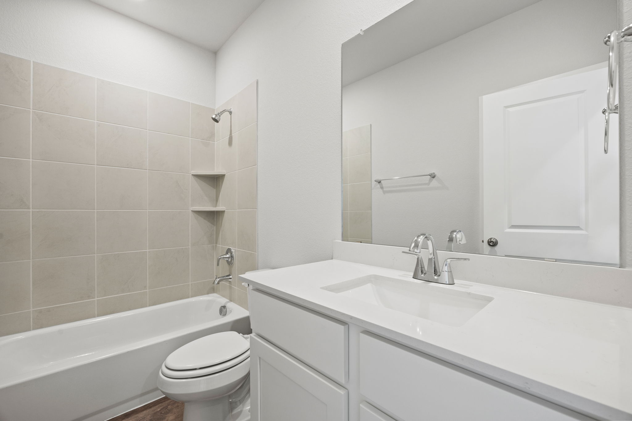 A bathroom with a tub sink and toilet.