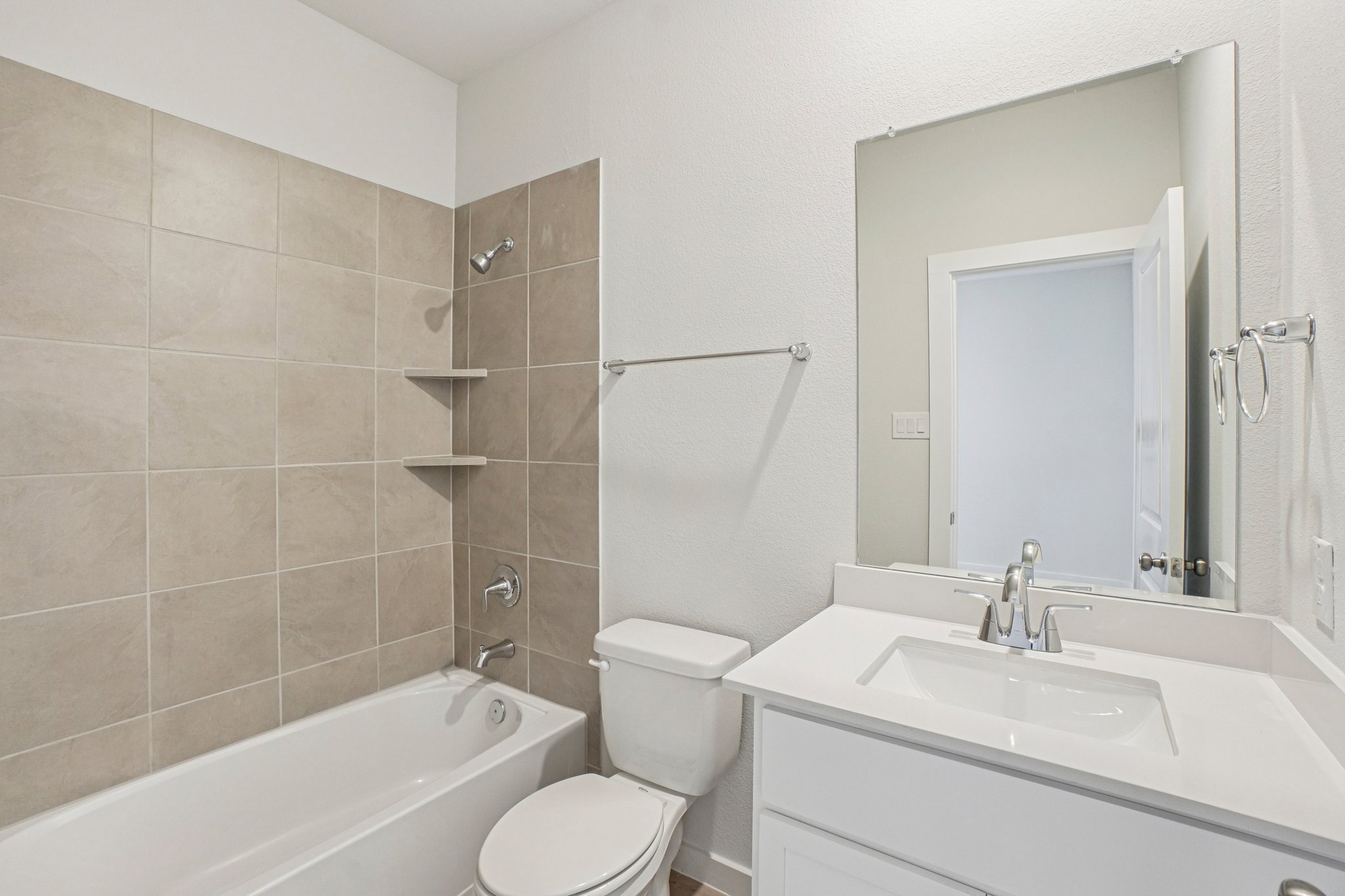 A bathroom with a tub sink and toilet.