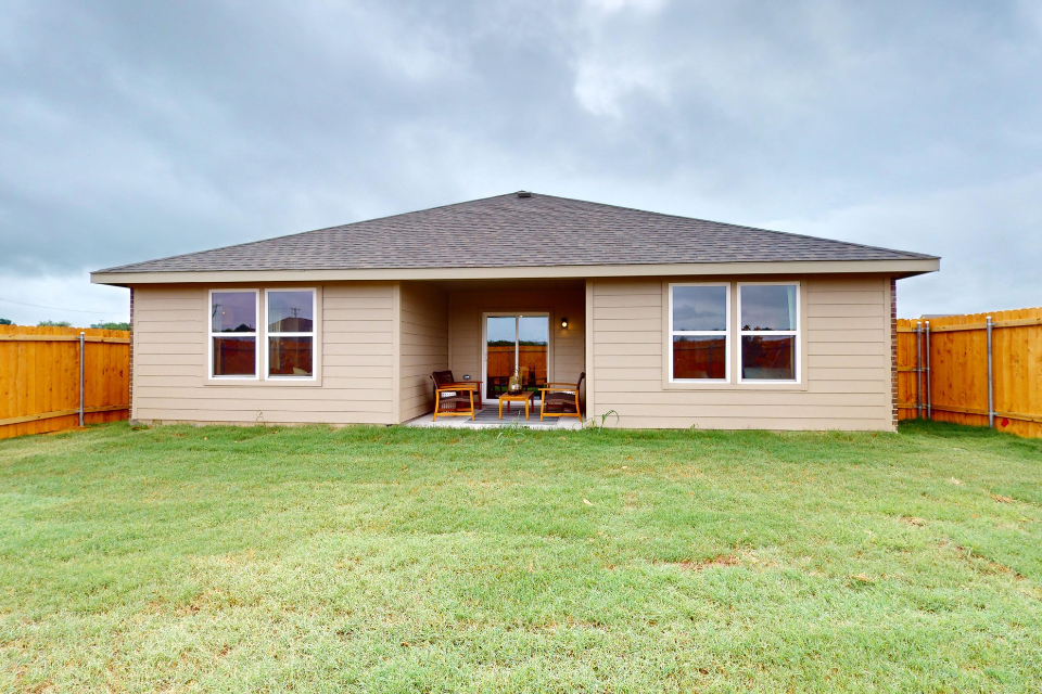 A house with a lawn in front of it.