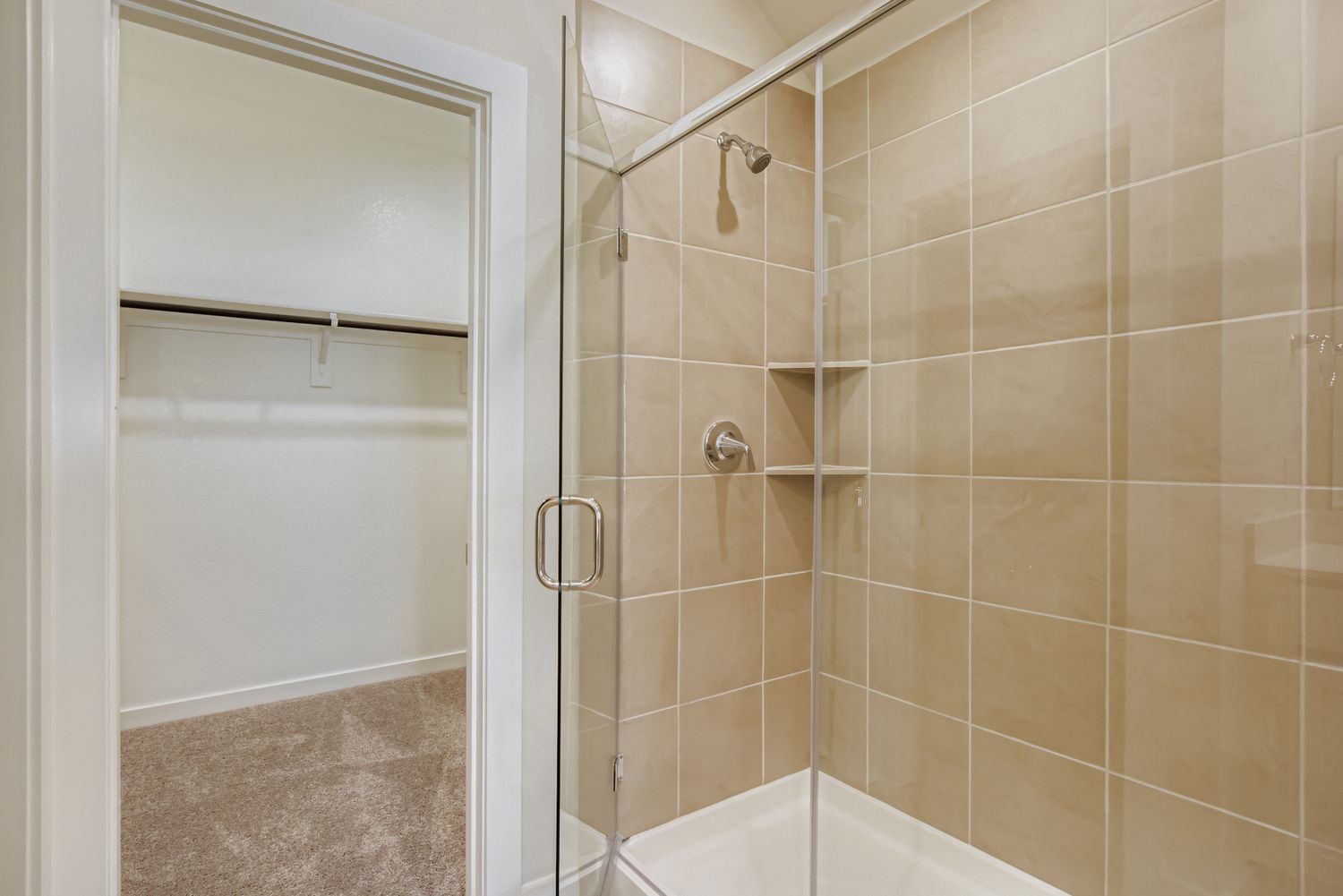 A shower with a glass door.