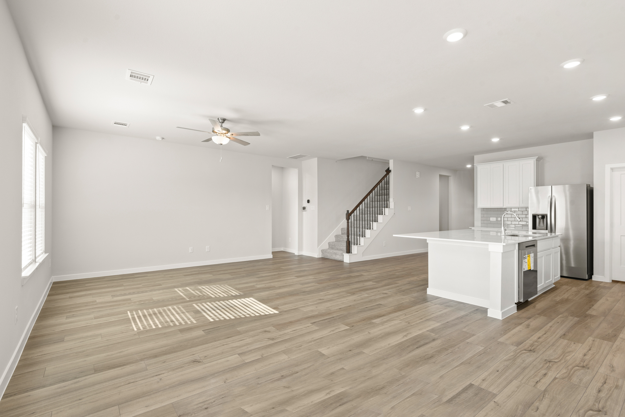 A large kitchen with white cabinets.