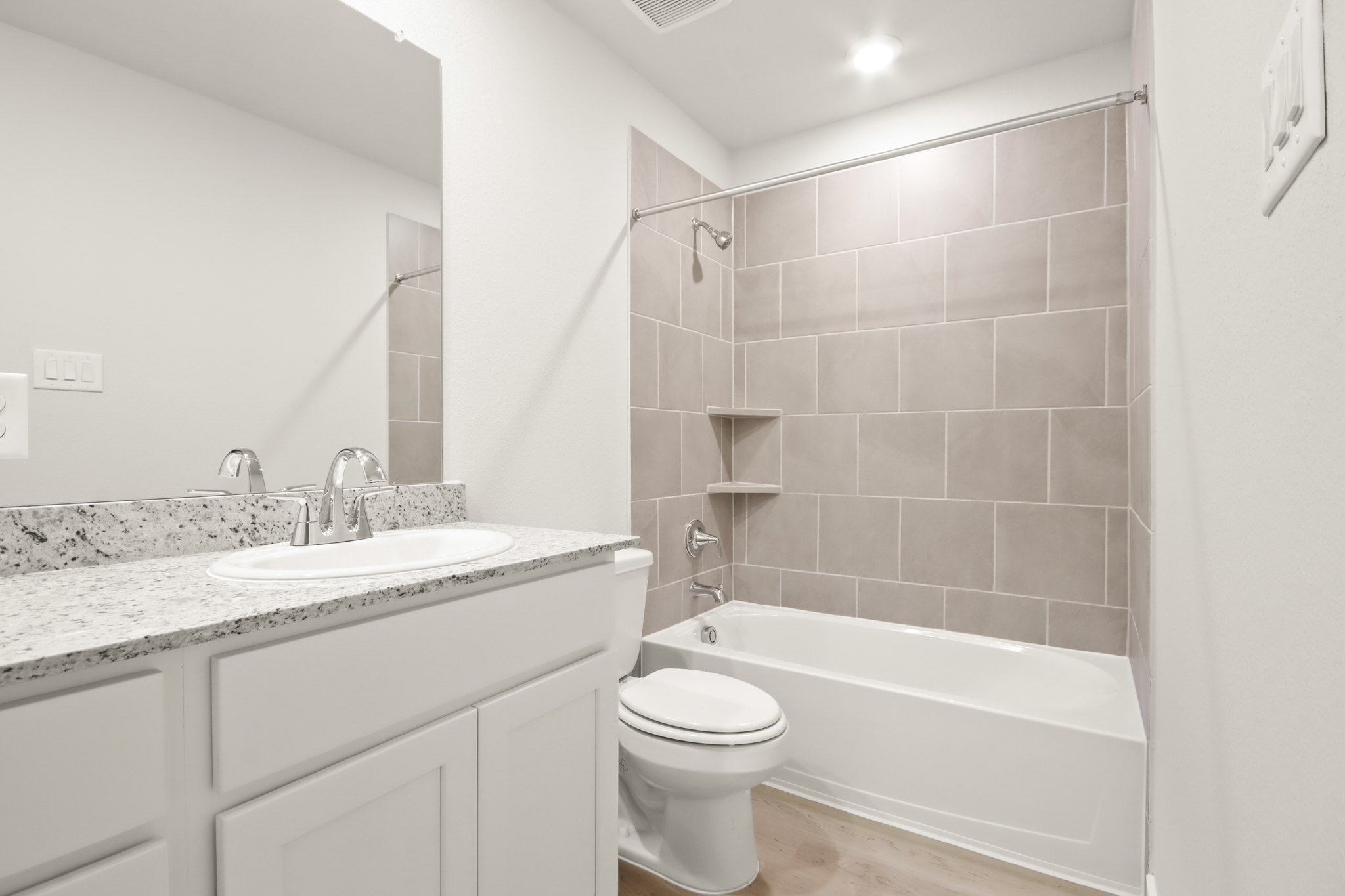 A bathroom with a tub sink and toilet.