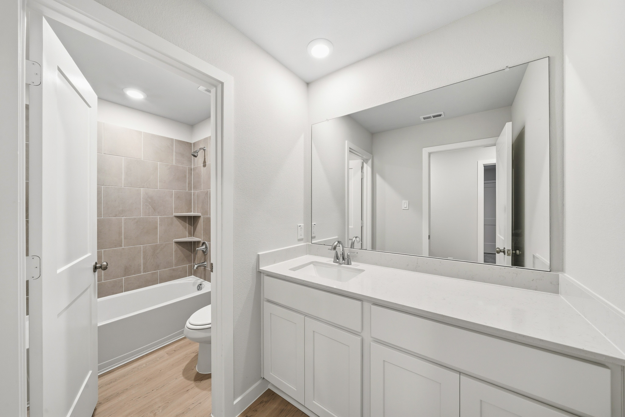 A bathroom with a tub sink and toilet.