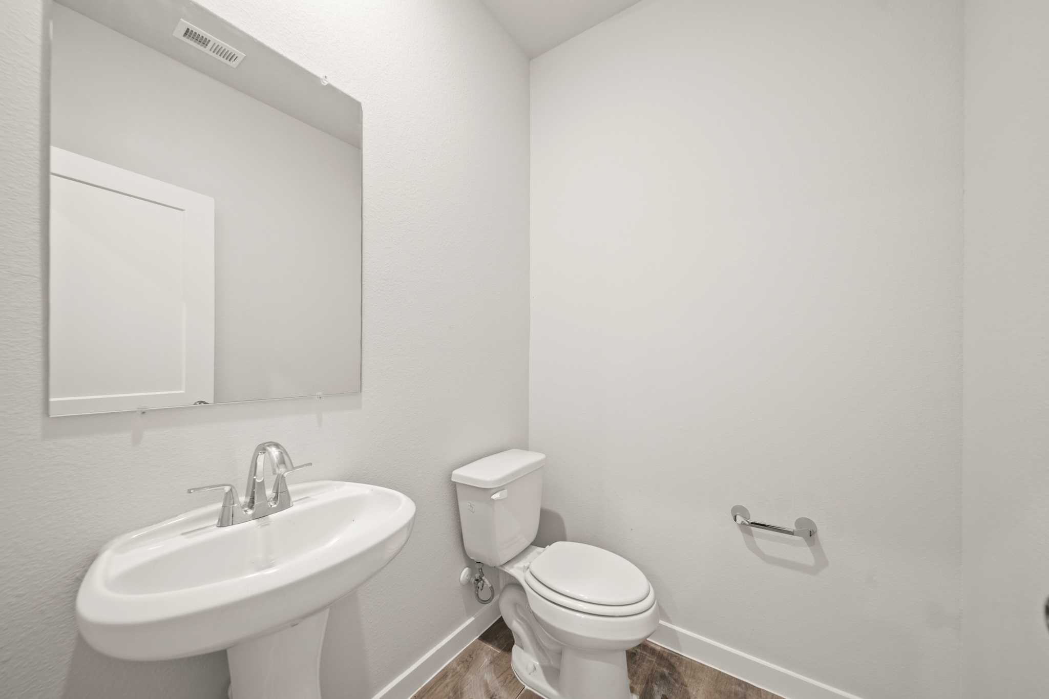 A bathroom with a toilet and sink.