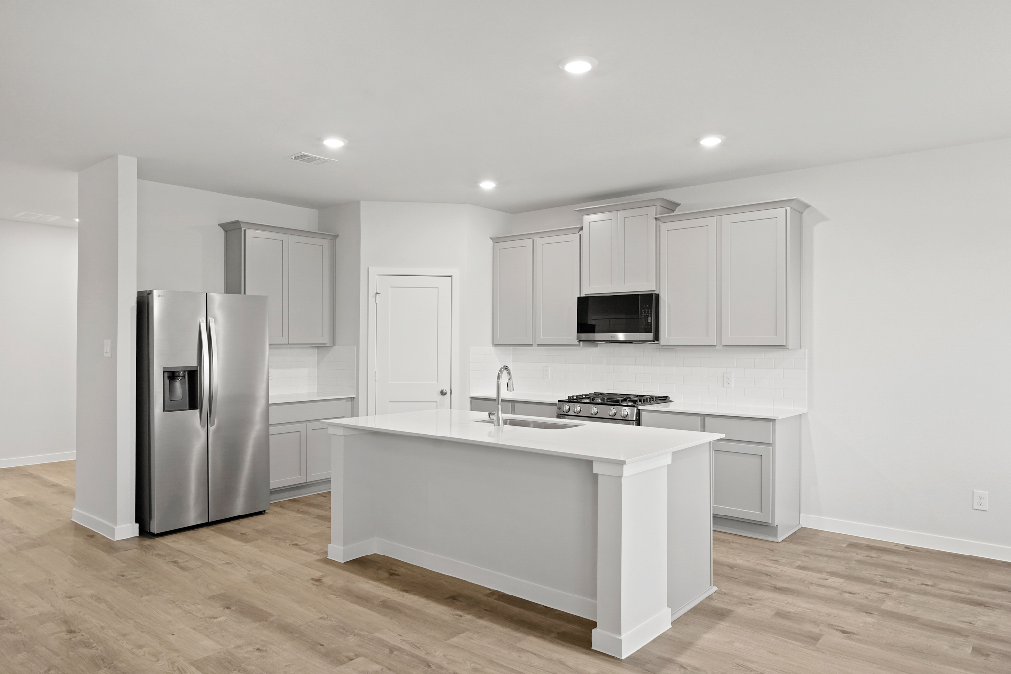A kitchen with white cabinets.