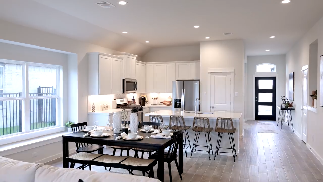 A kitchen with a dining table.