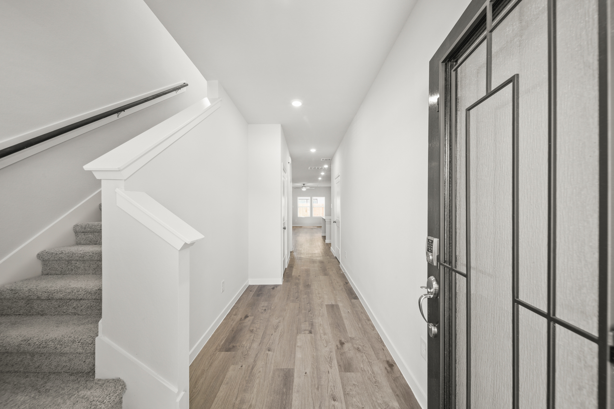 A hallway with white walls.