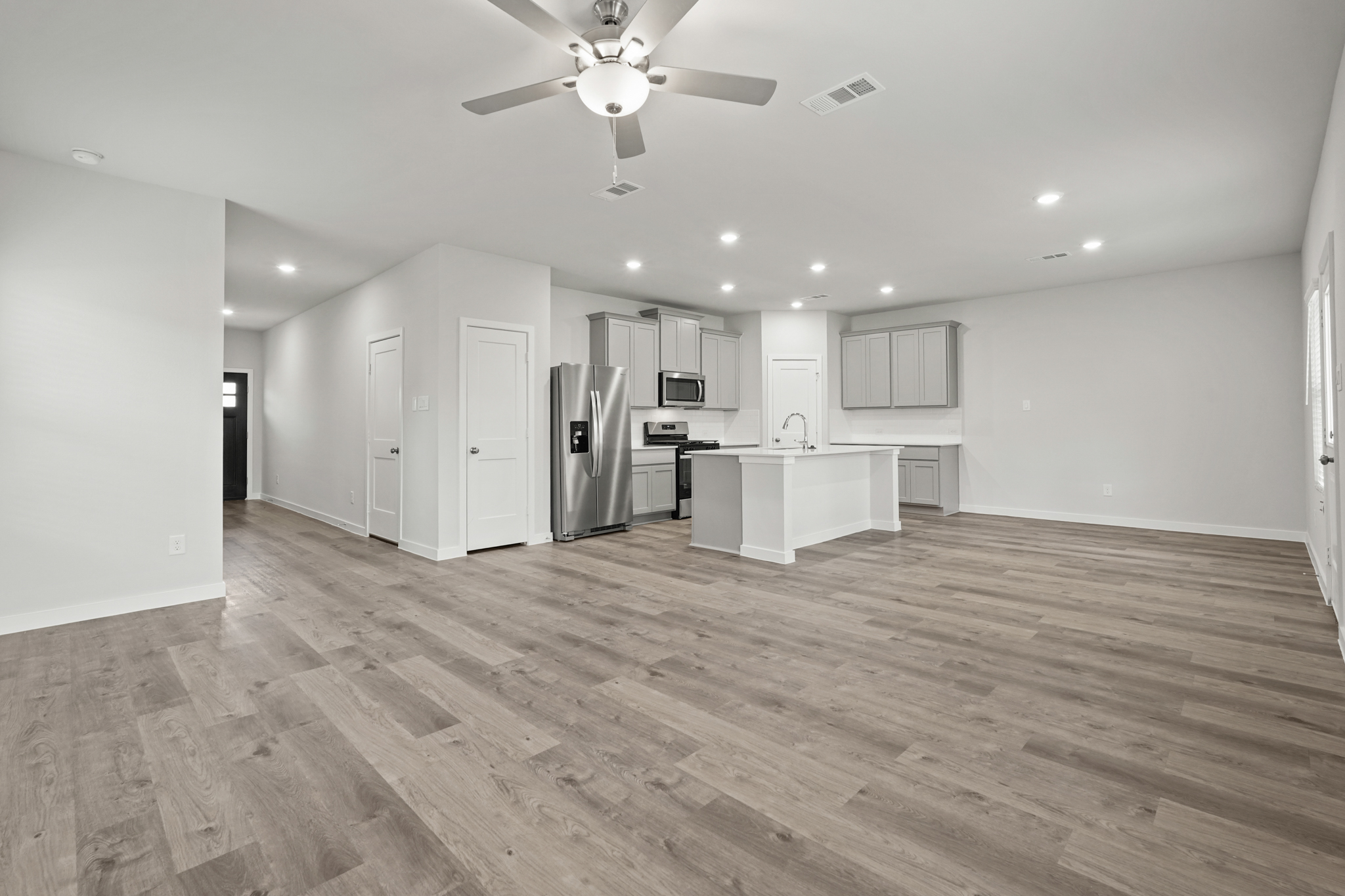 A kitchen with white cabinets.
