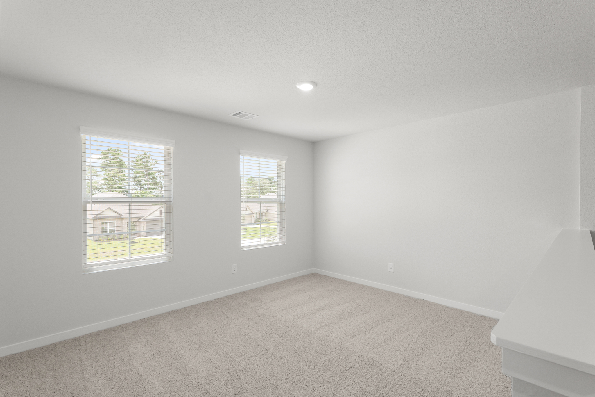 A room with a window and a couch.