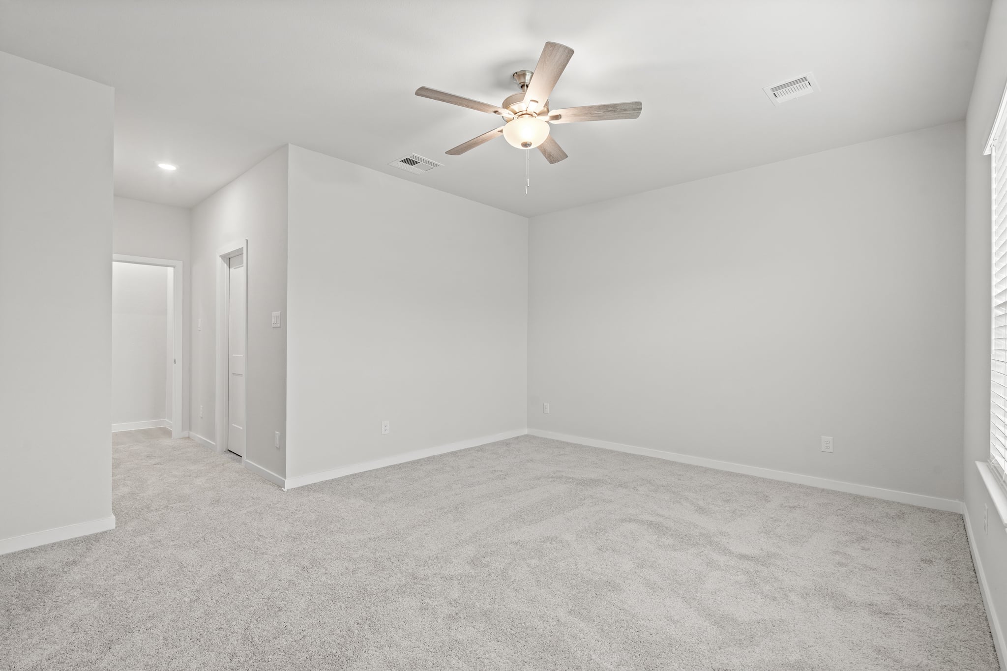 A room with a ceiling fan and a ceiling fan.