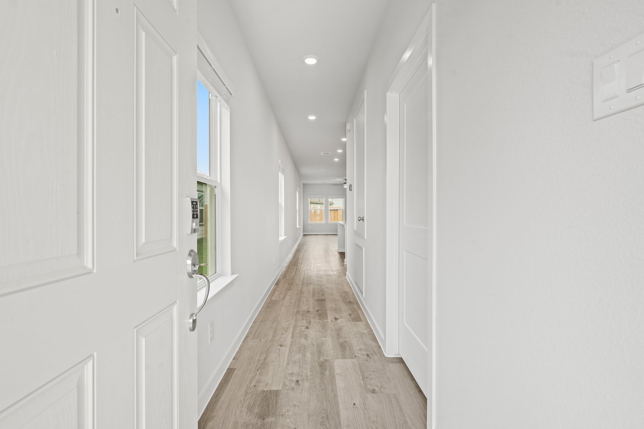 A hallway with white doors.