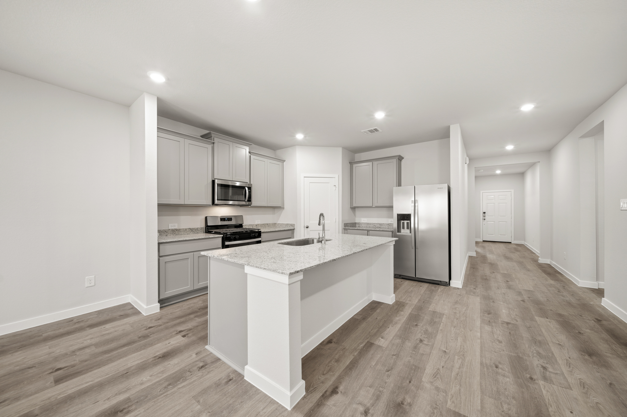 A kitchen with white cabinets.