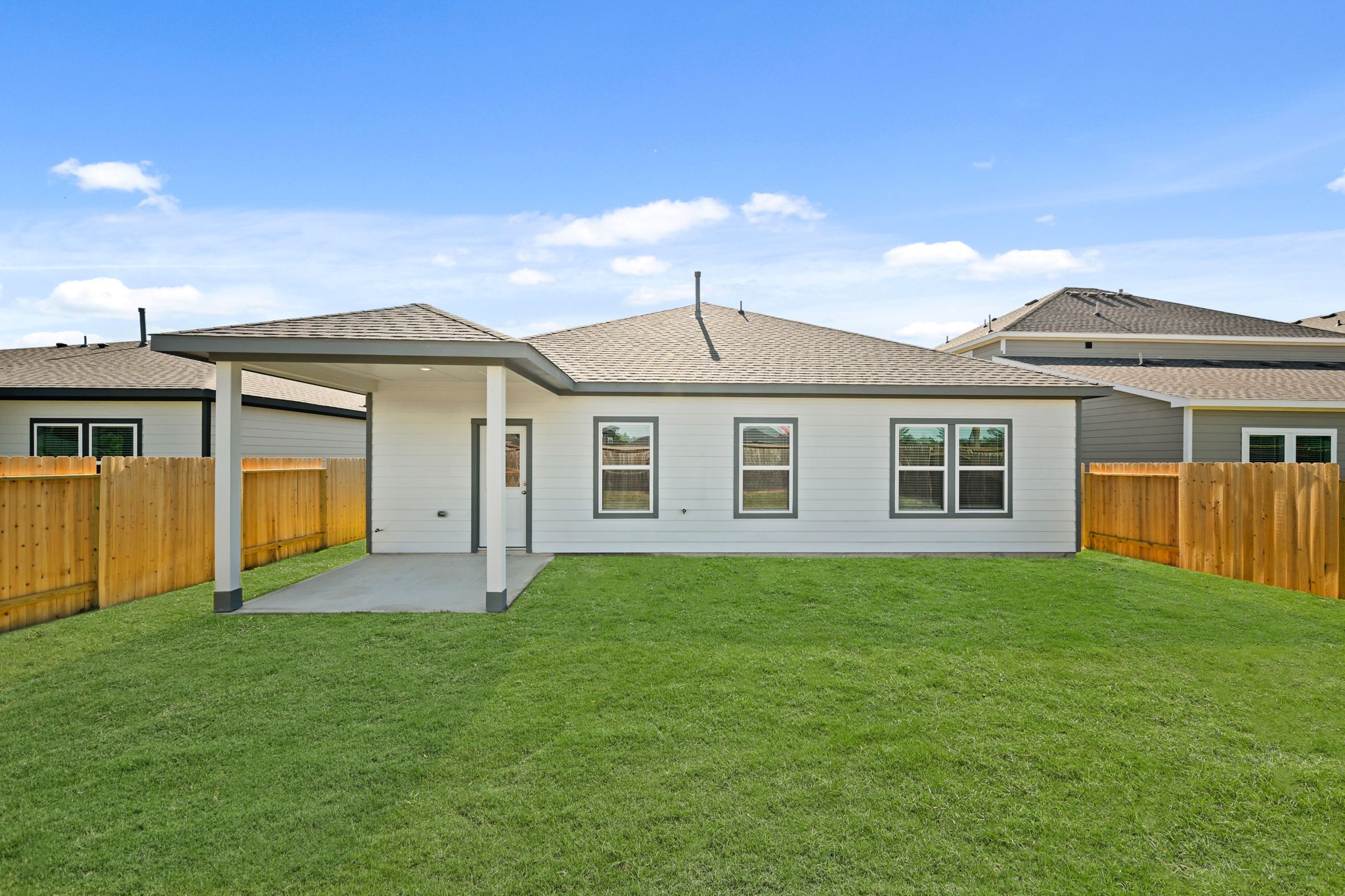 A house with a fence and grass.
