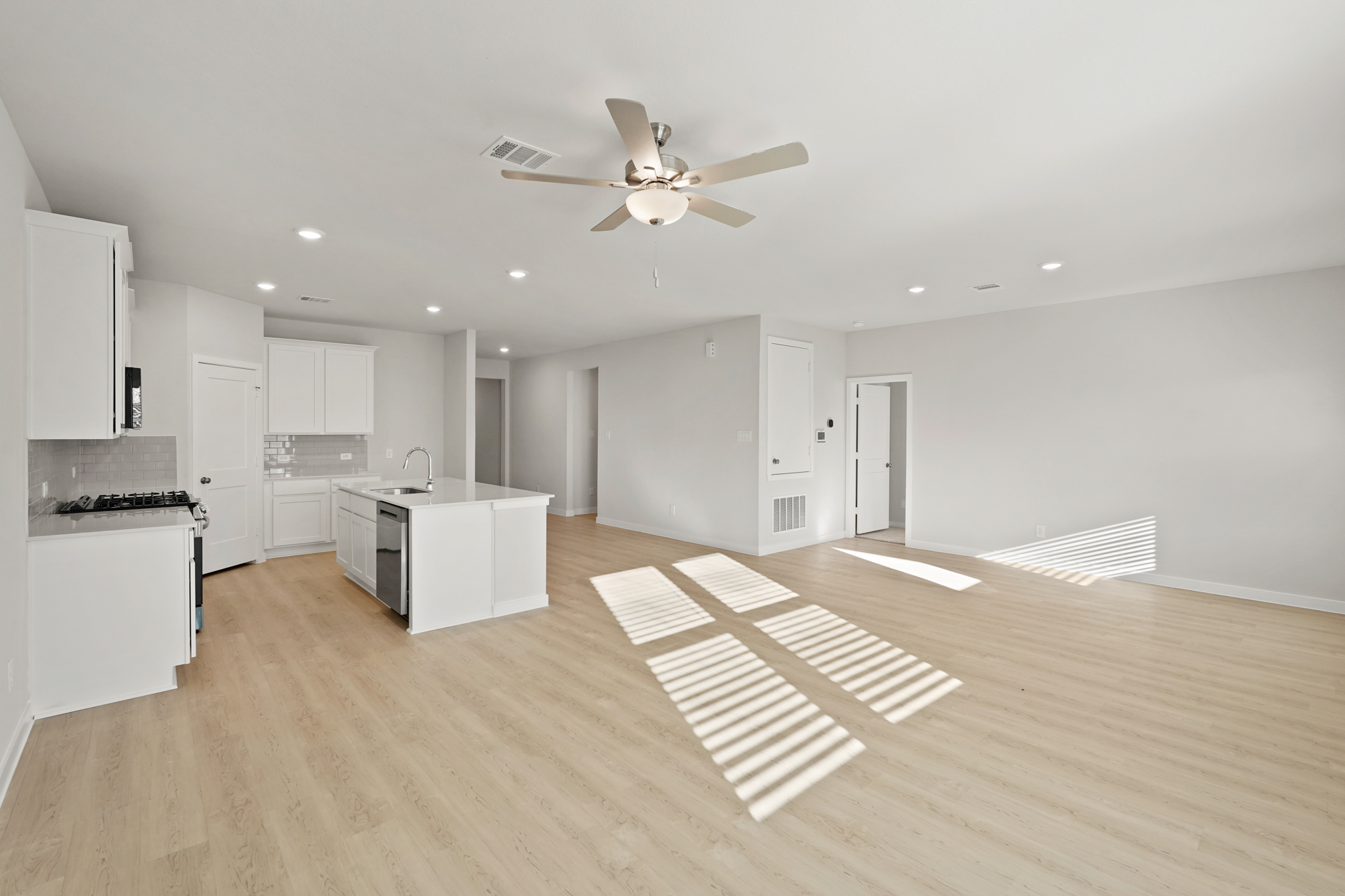 A large kitchen with white cabinets.