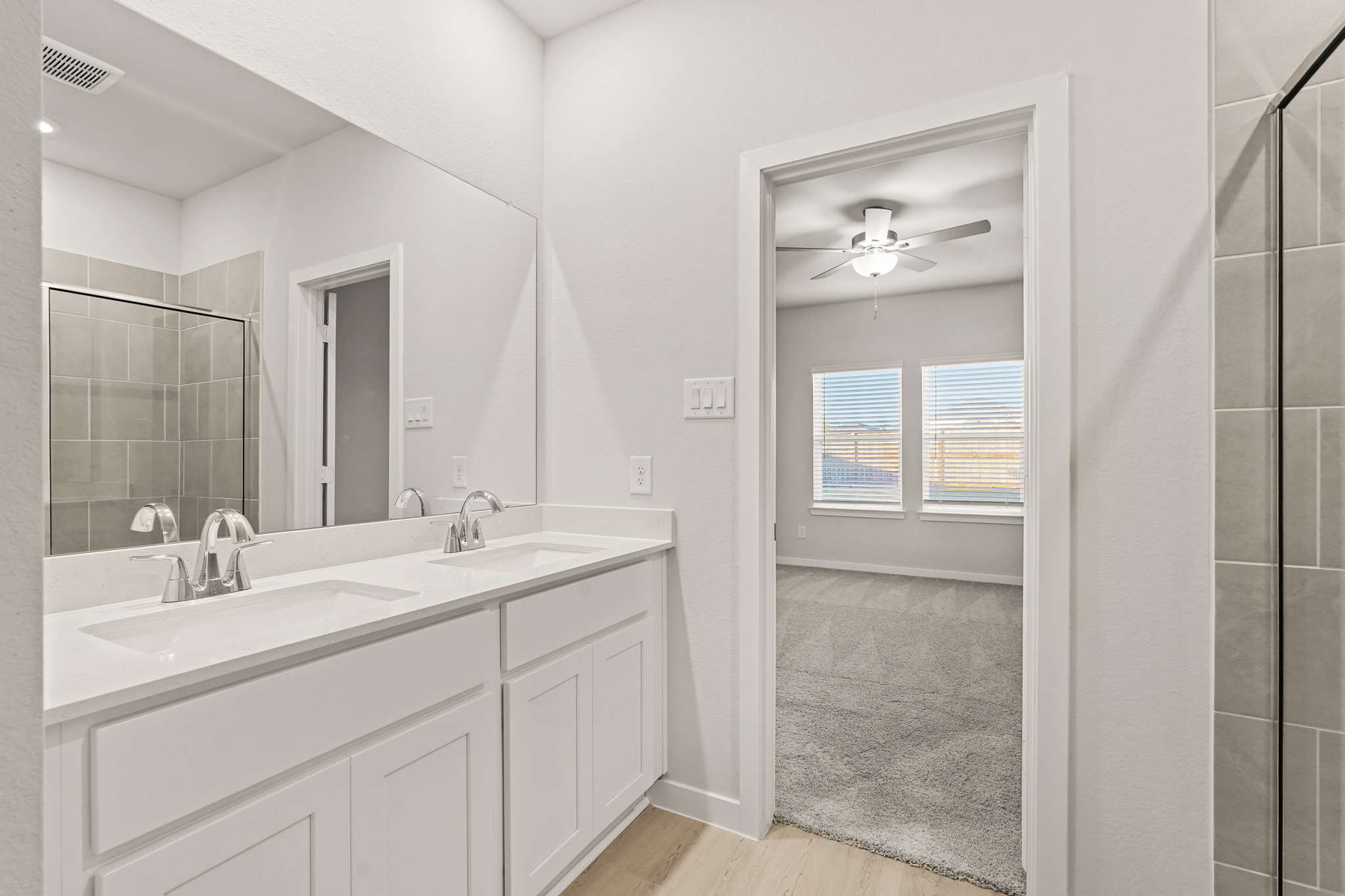 A bathroom with a large mirror.