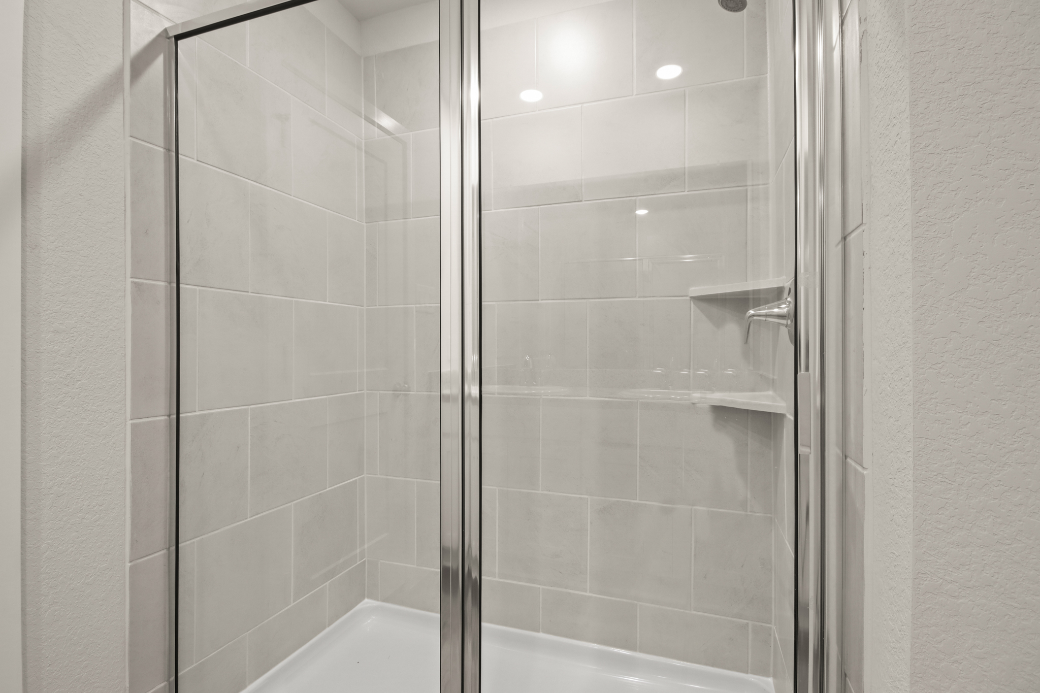 A shower with a glass door.
