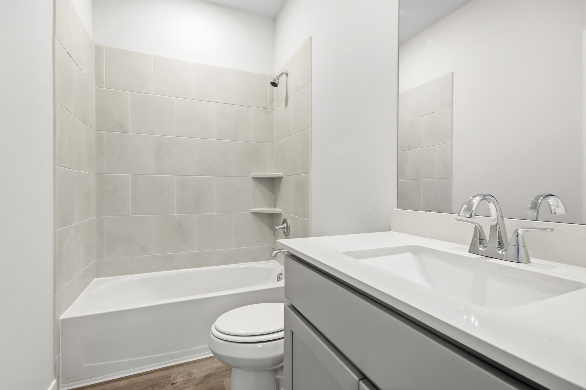 A bathroom with a tub toilet and sink.