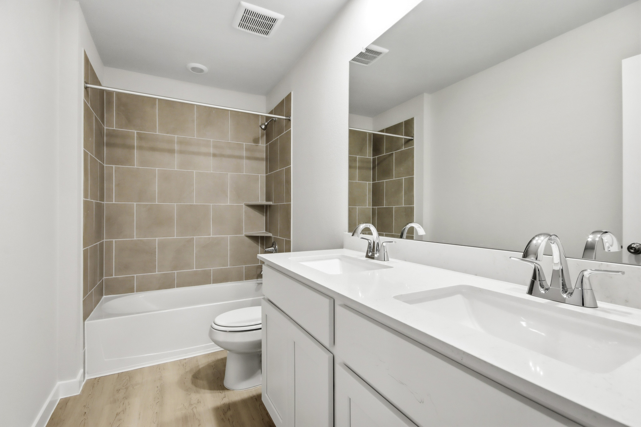 A bathroom with a tub sink and toilet.