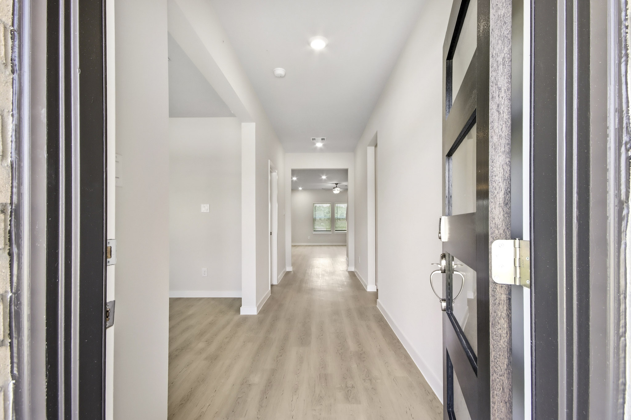 A hallway with white walls.