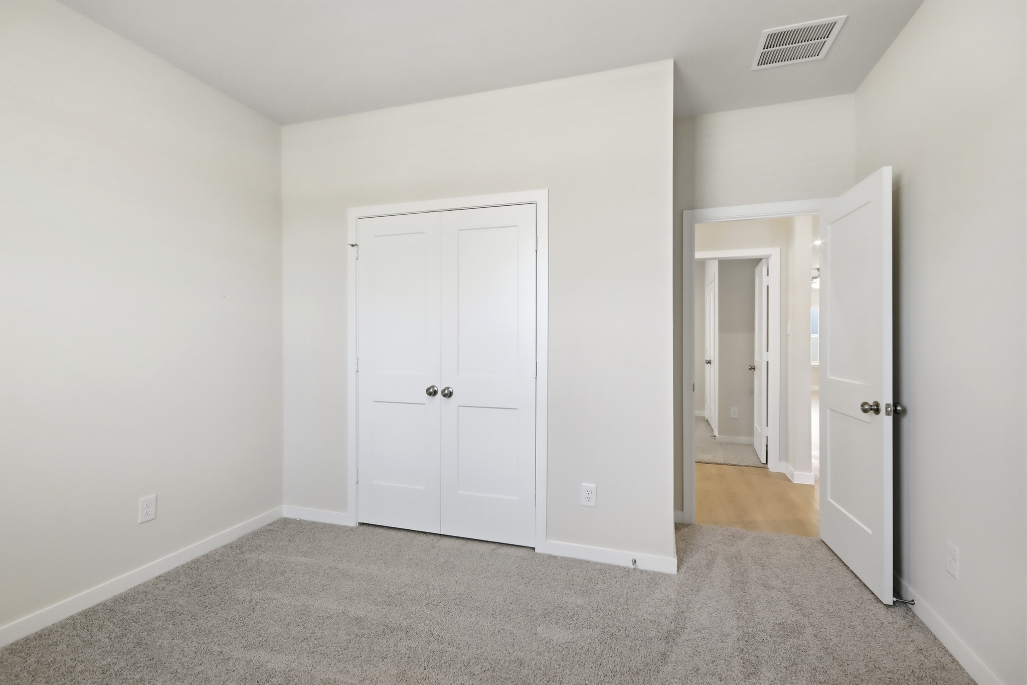 A hallway with white doors.