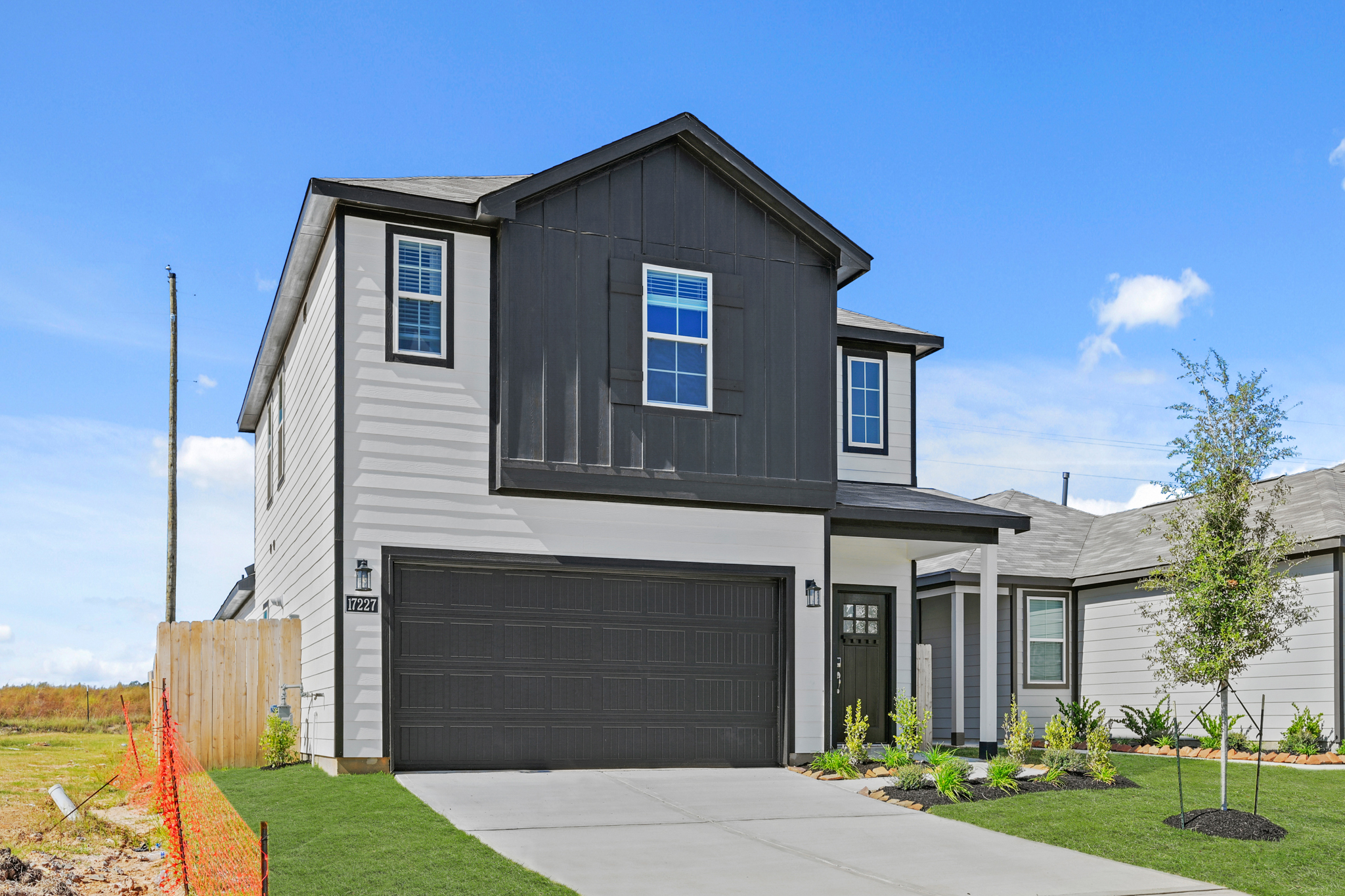 A grey house with a garage.