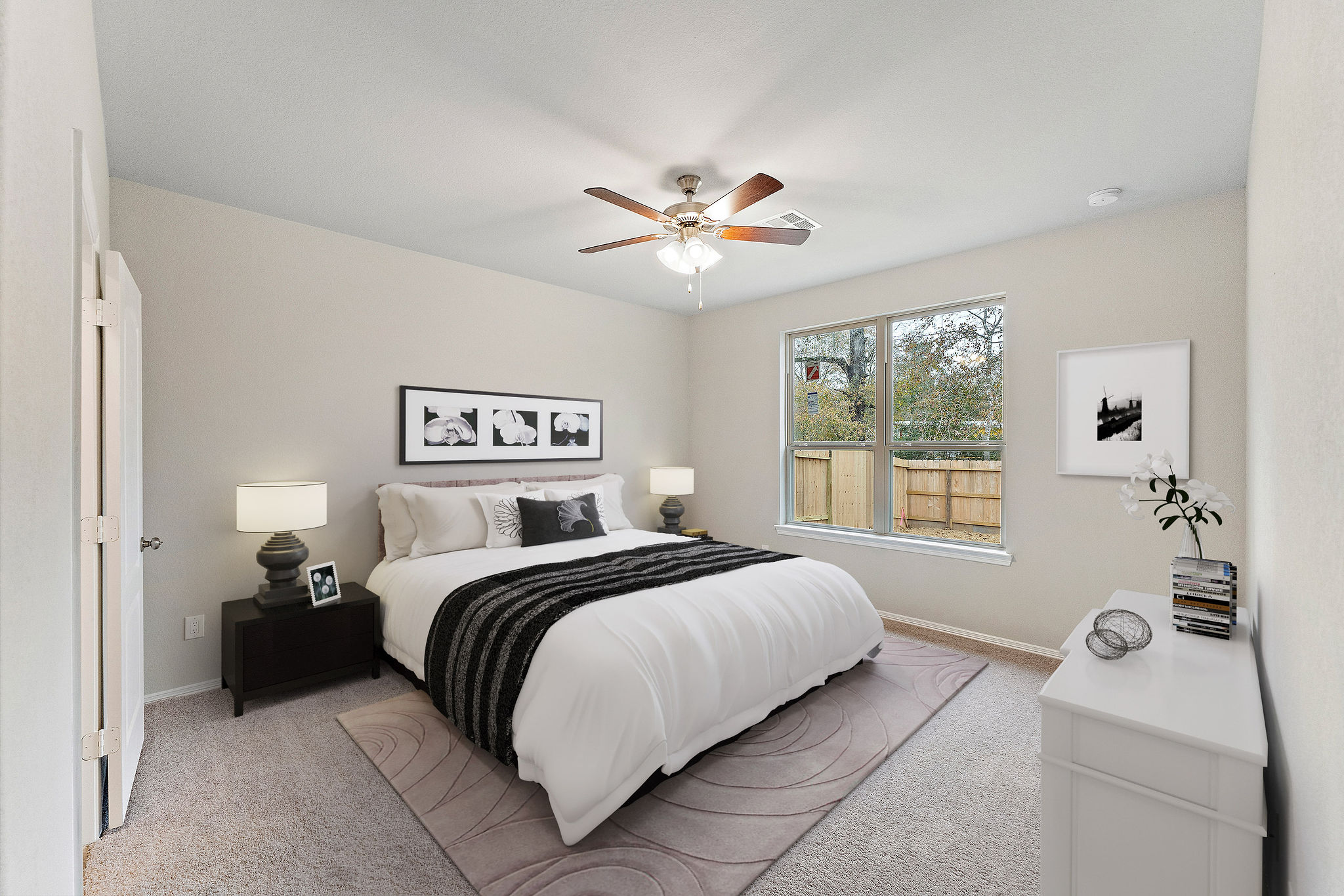 A bedroom with a bed and a fan.