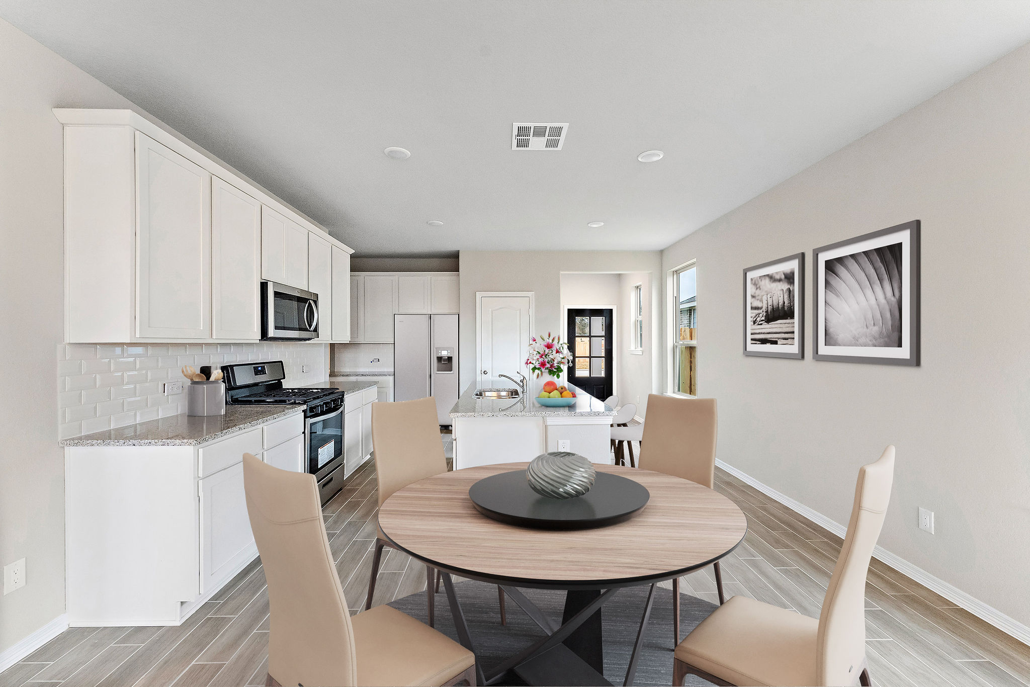 A kitchen with a dining table.