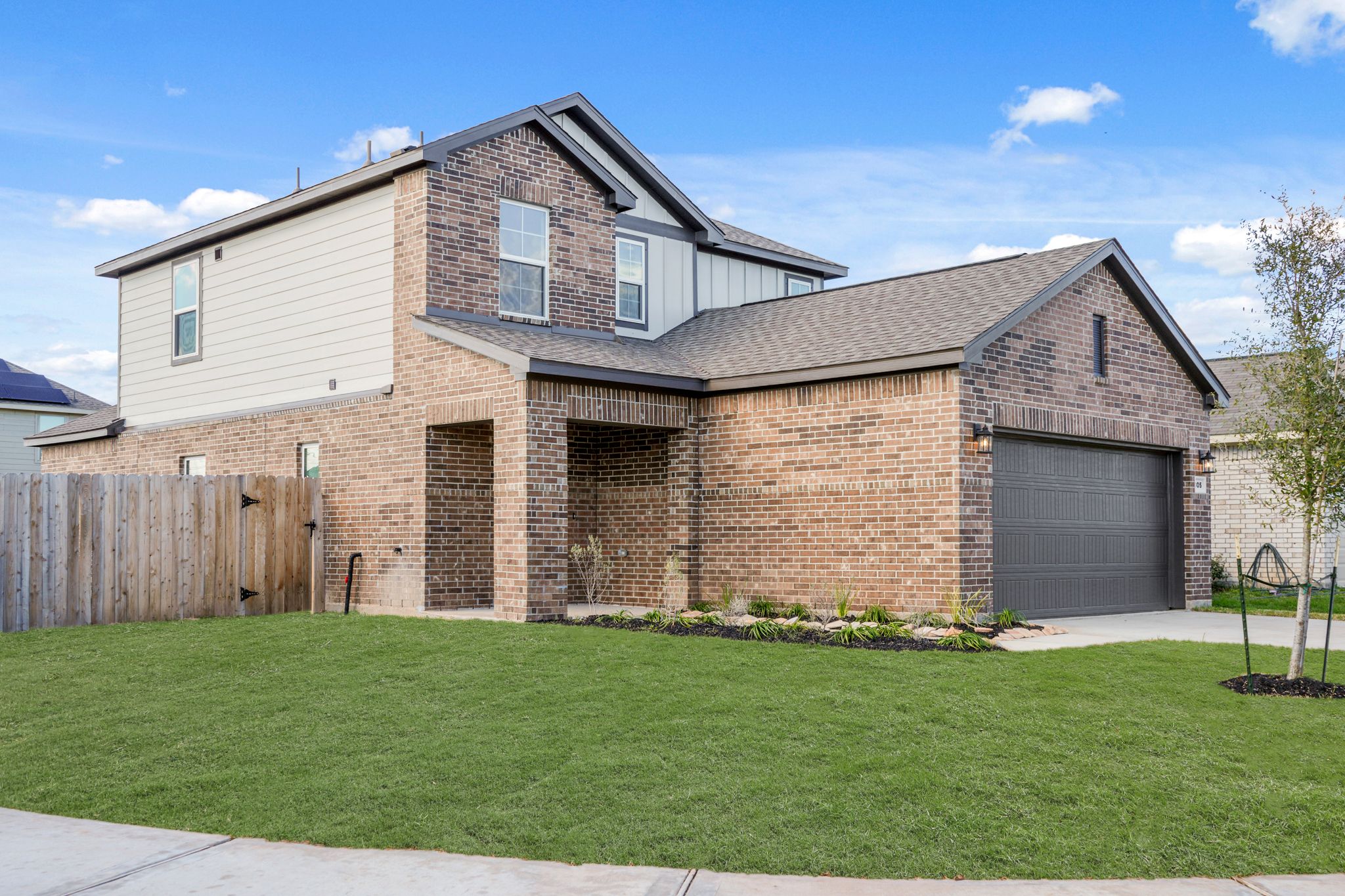 A brick house with a fence.