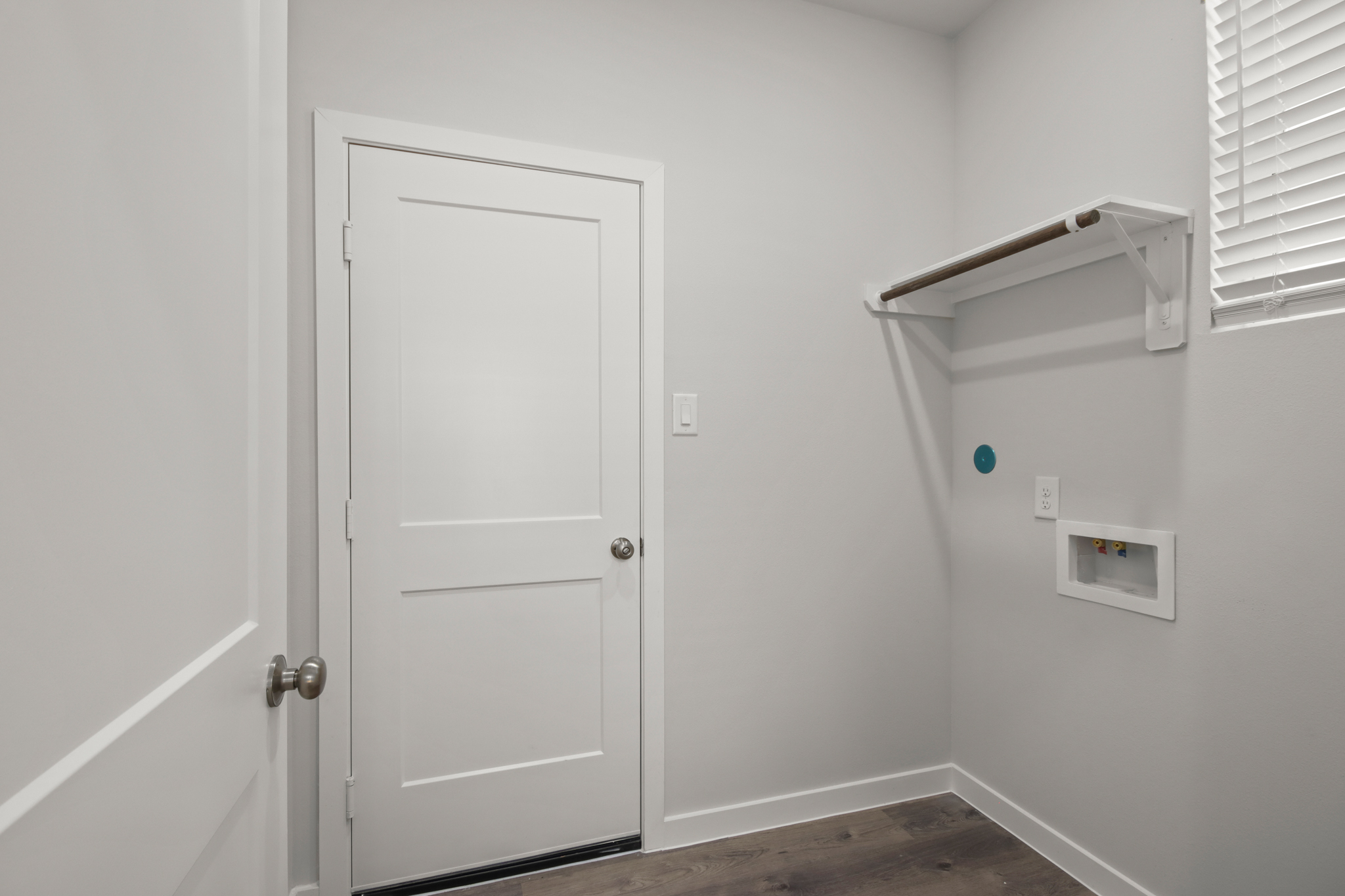 A white door with a light above it.