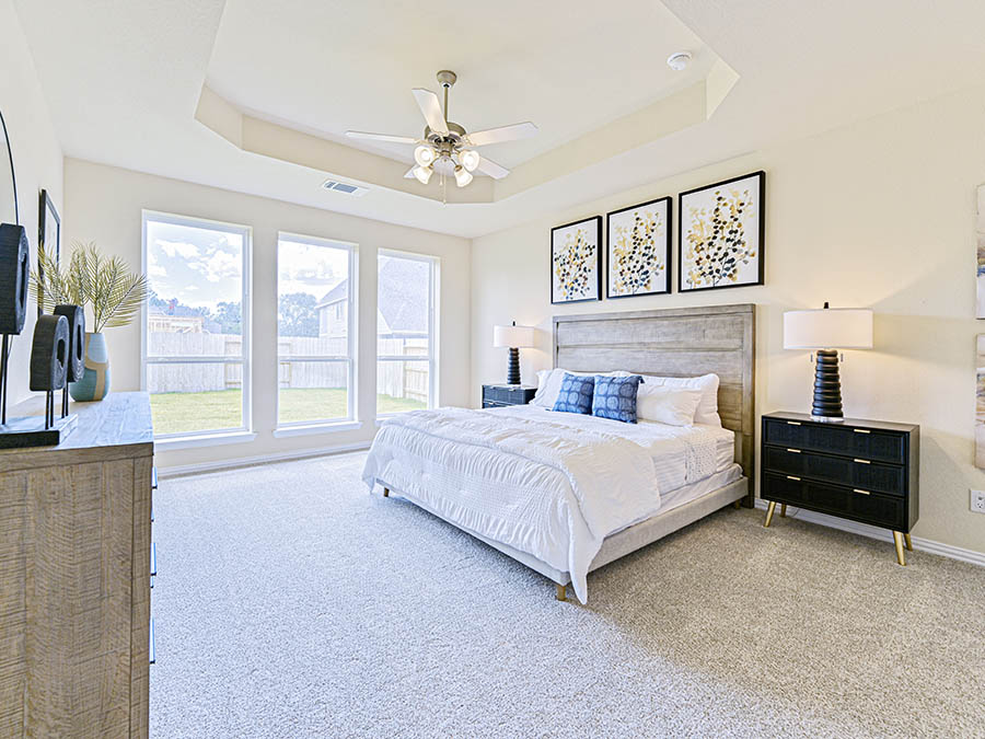 A bedroom with a large window.