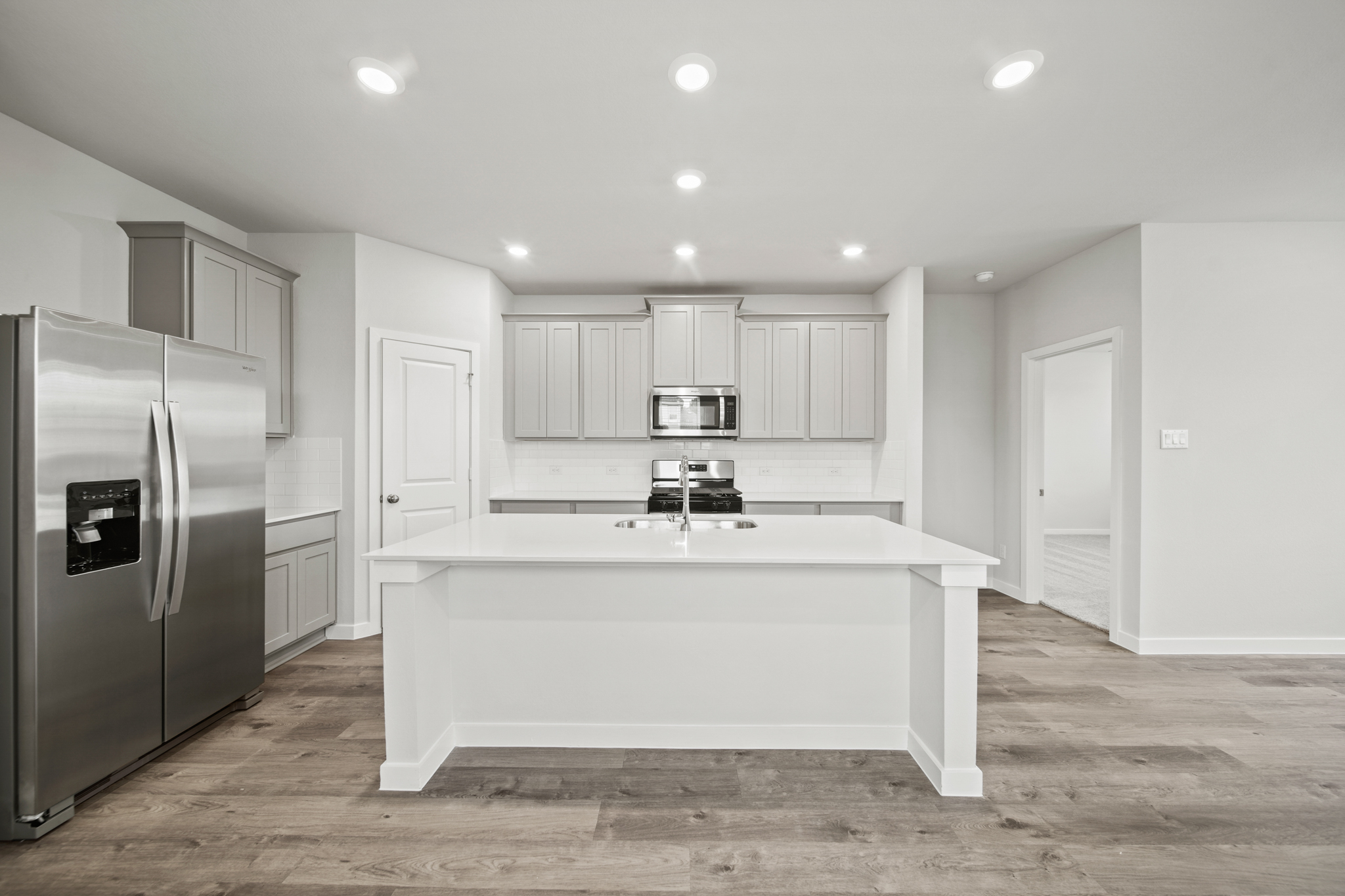 A kitchen with white cabinets.