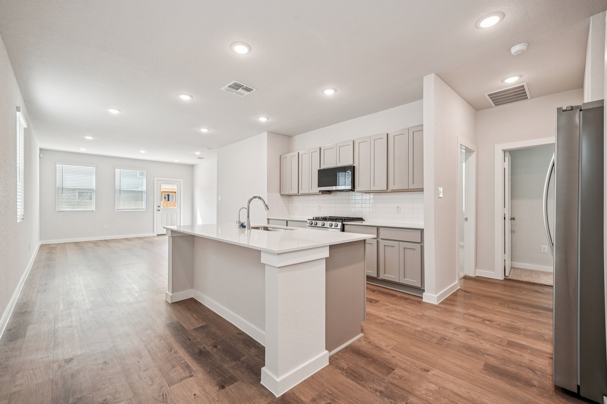 A kitchen with white cabinets.