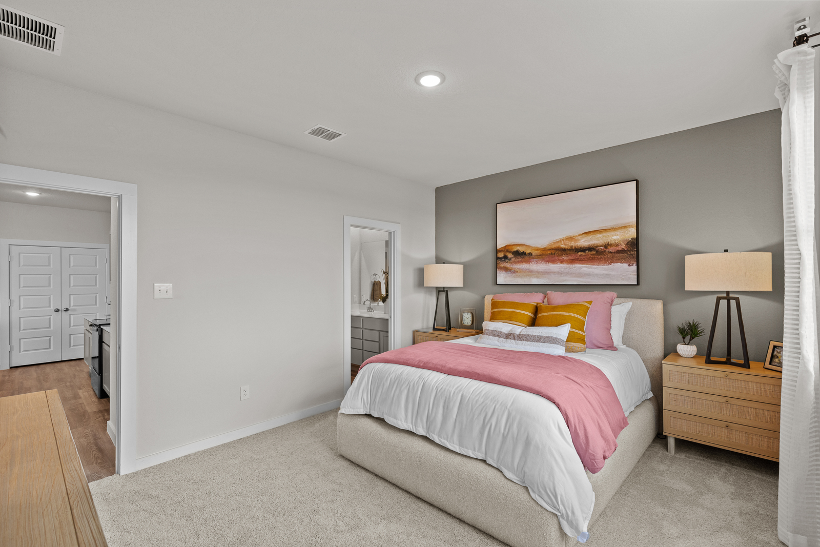 A bedroom with a bed and lamps.