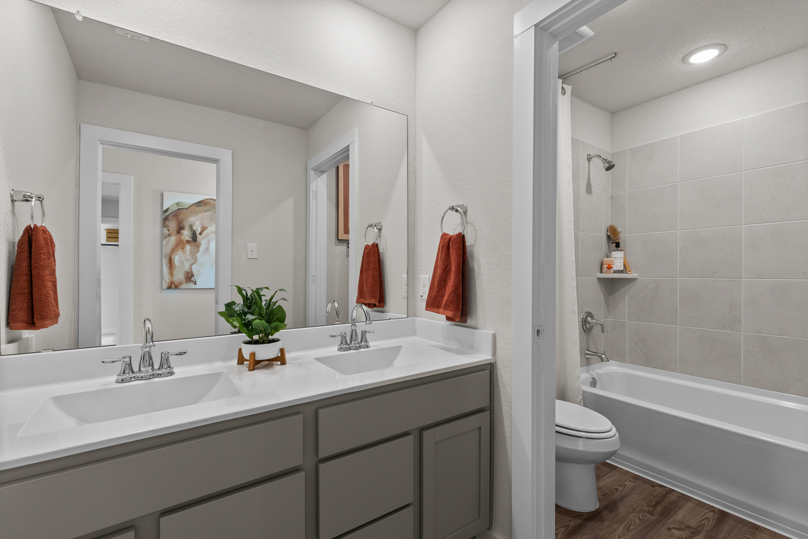 A bathroom with a tub sink and toilet.