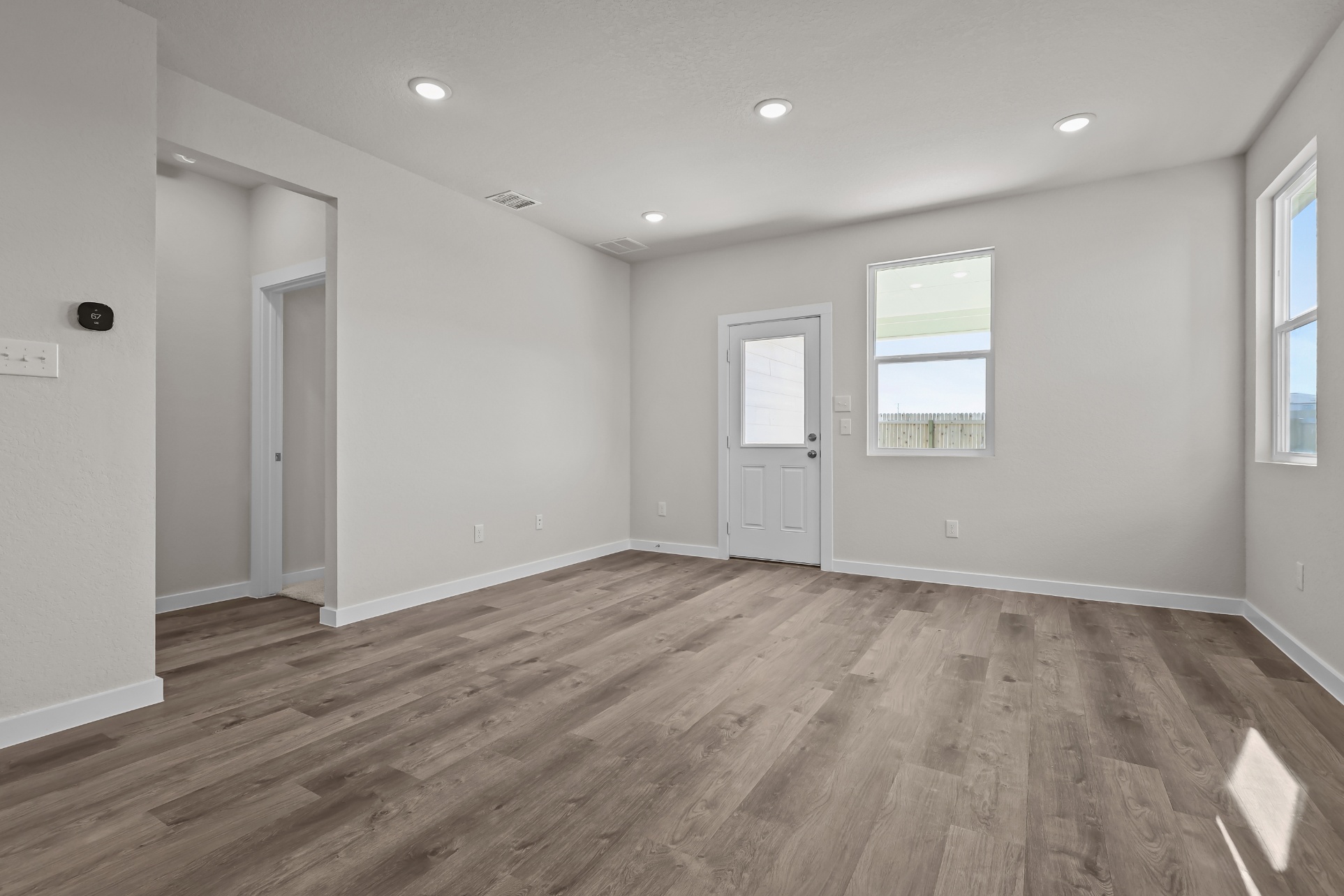 A room with a wood floor and white doors.