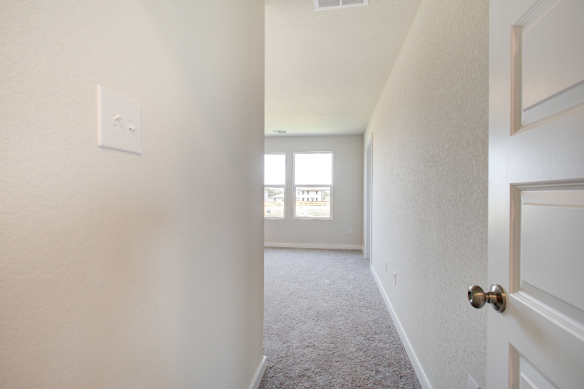 A hallway with white walls.