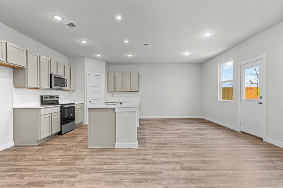 A kitchen with white cabinets.
