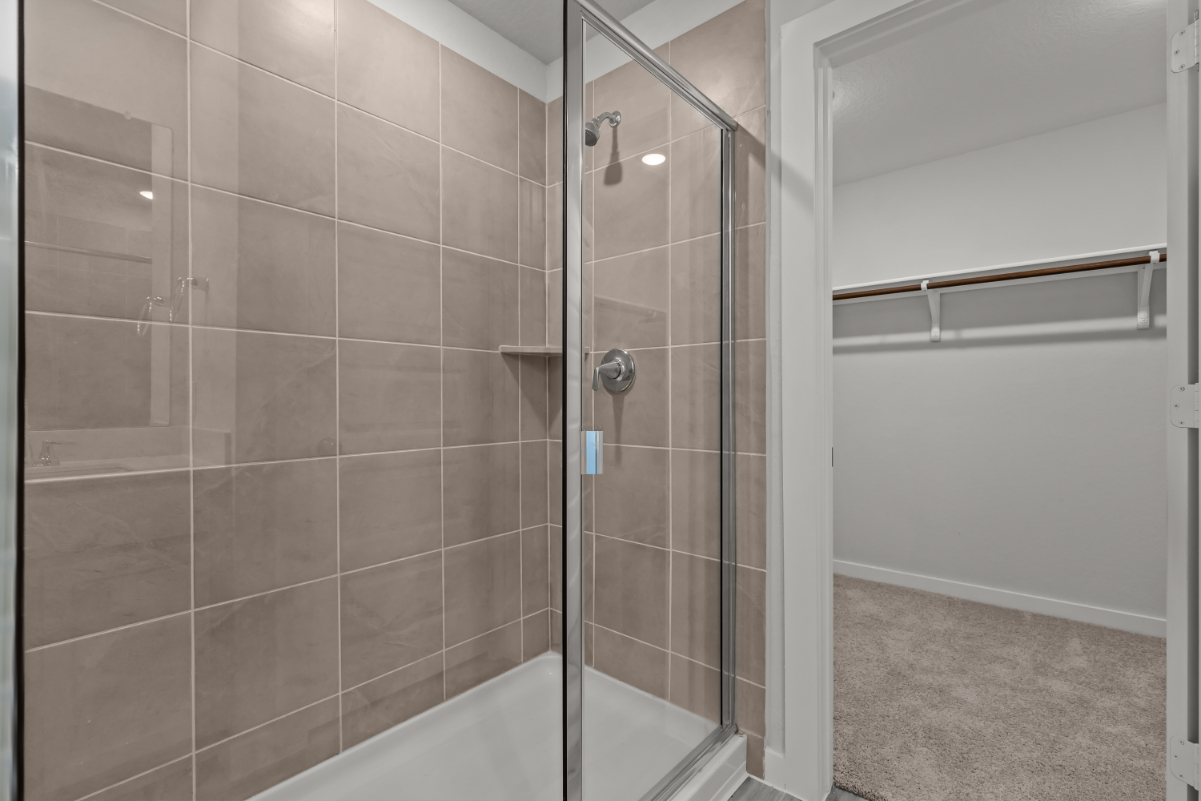 A shower with a glass door.