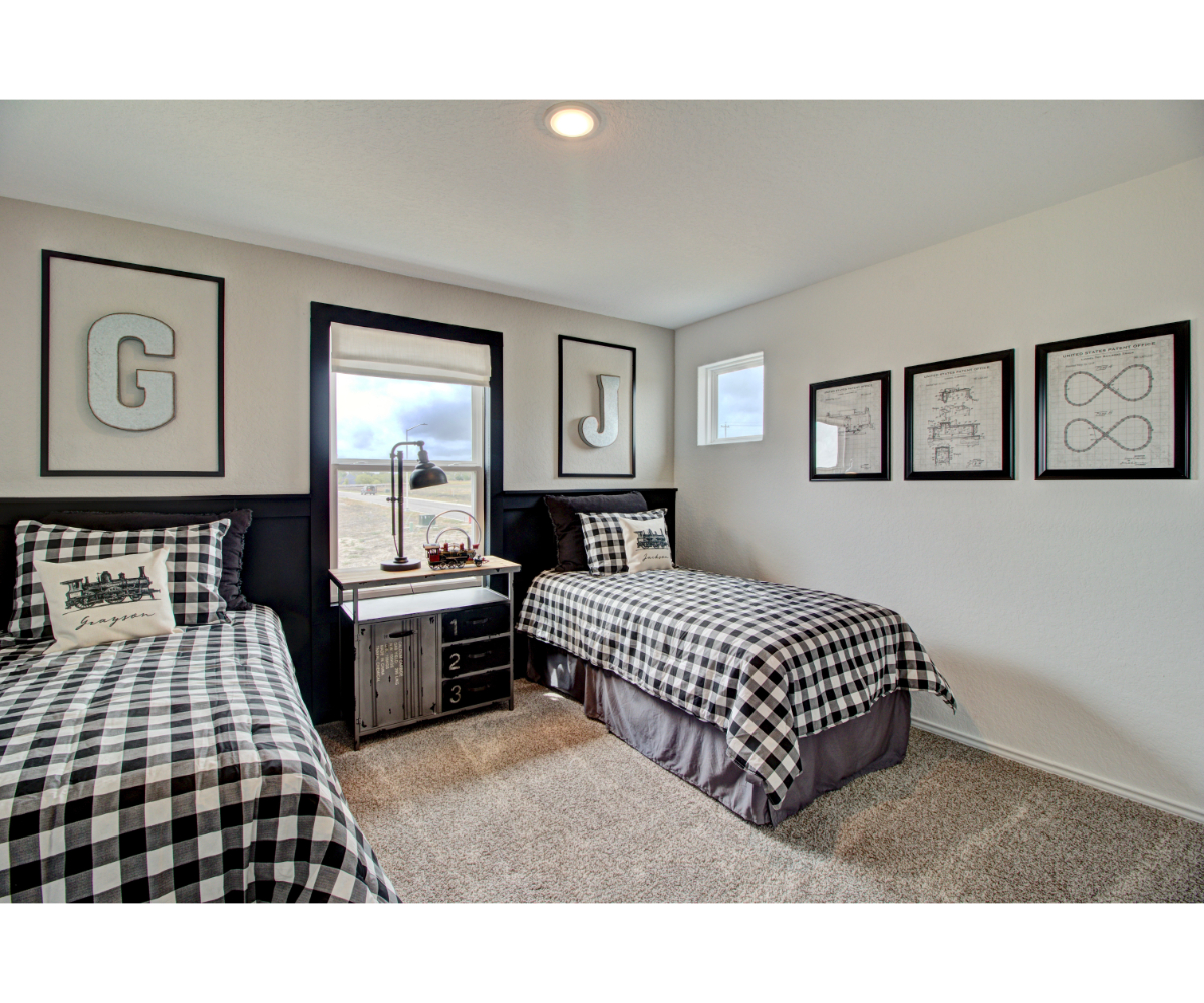 A bedroom with a bed and a mirror.