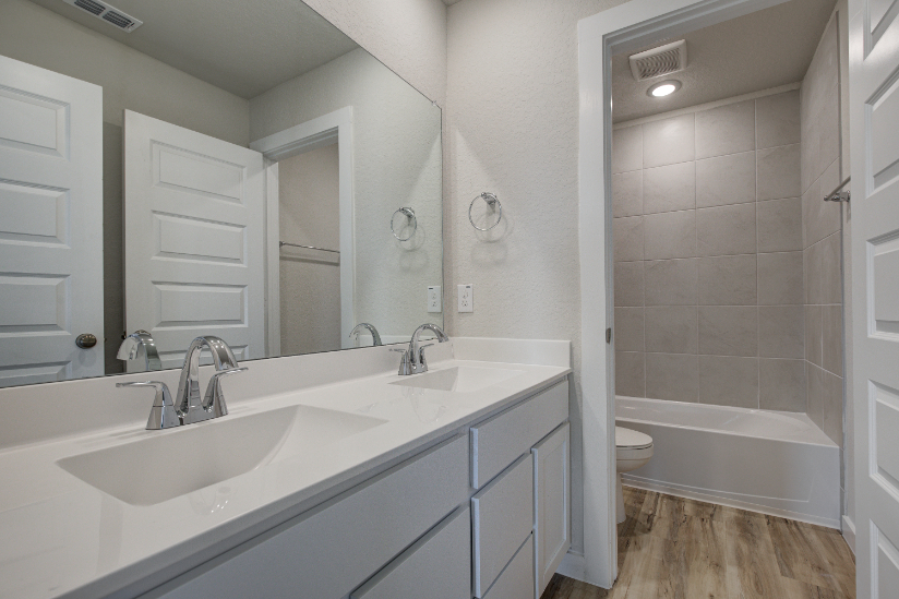 A bathroom with a tub sink and toilet.