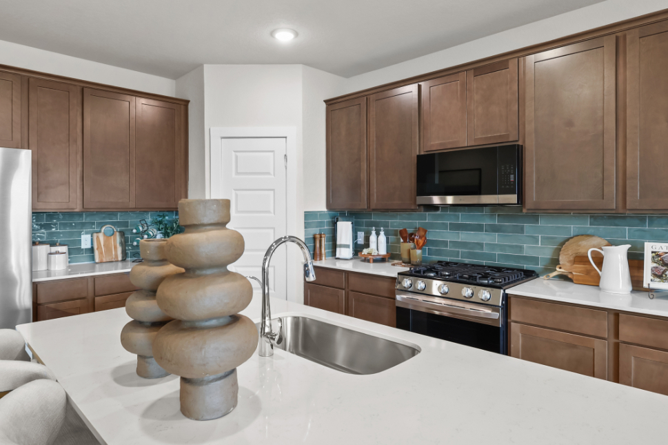 A kitchen with wooden cabinets.