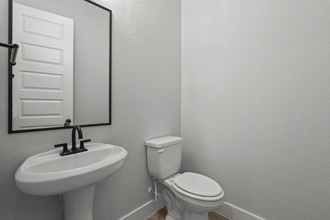 A bathroom with a toilet and sink.